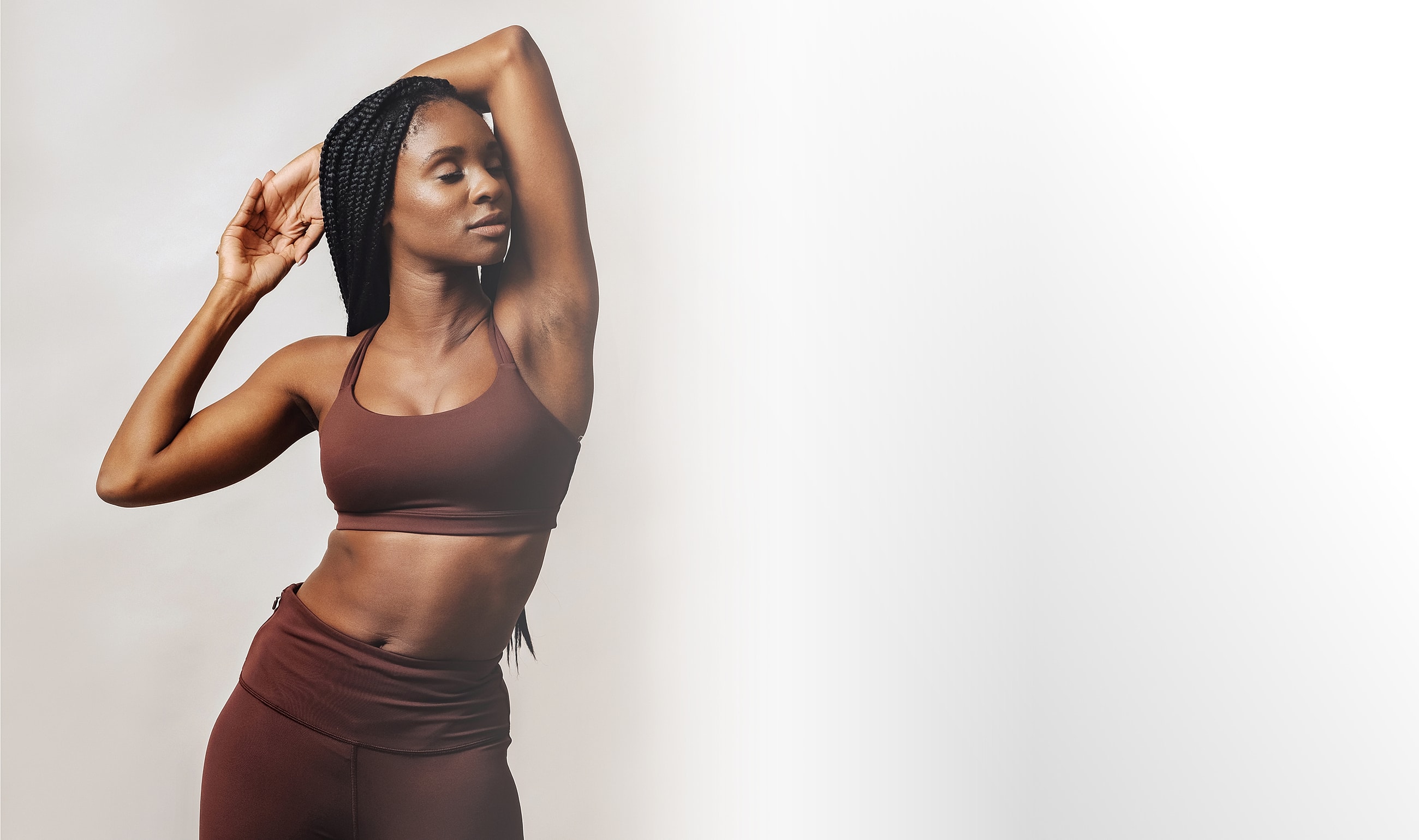 Woman in athletic wear posing confidently.
