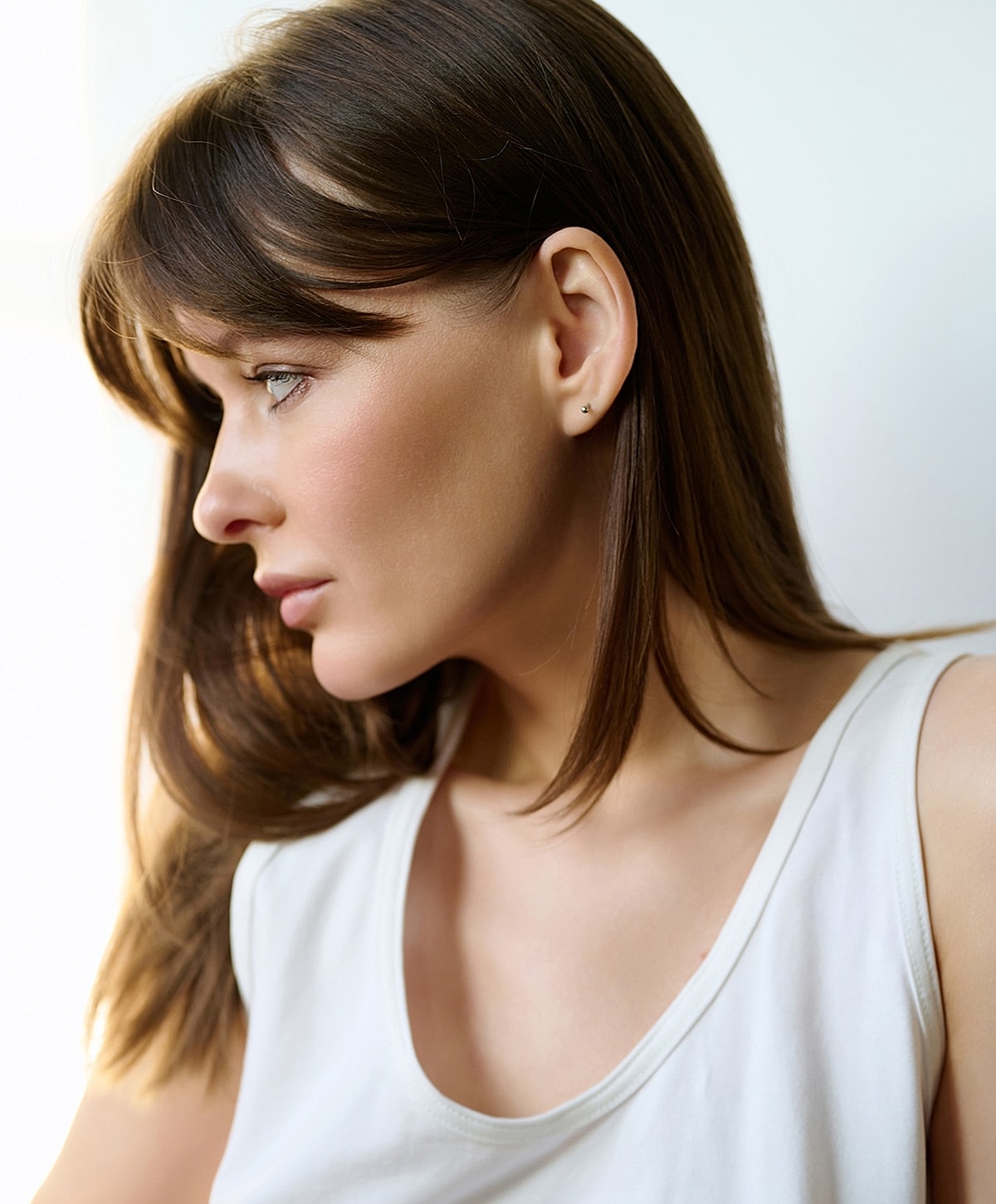 Woman with light brown hair in profile.