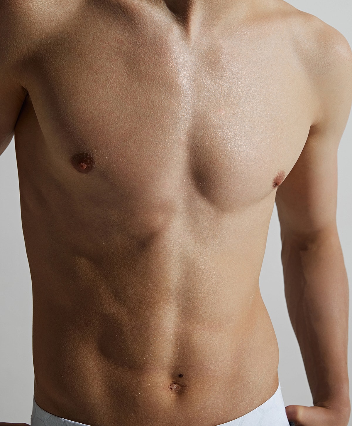 Gainesville, FL gynecomastia Surgery model with defined muscles and smooth skin.