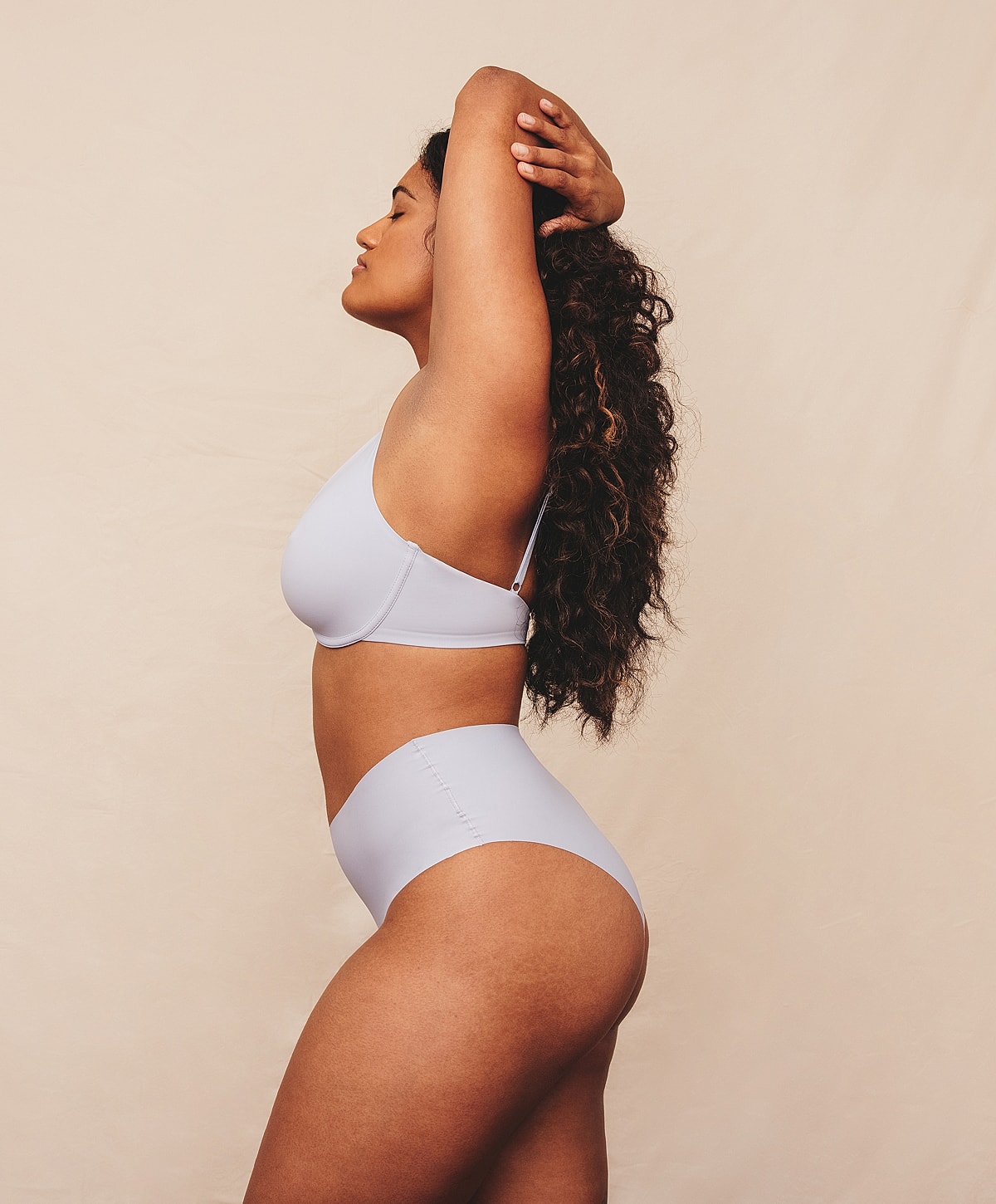 Model in light lingerie posing gracefully.