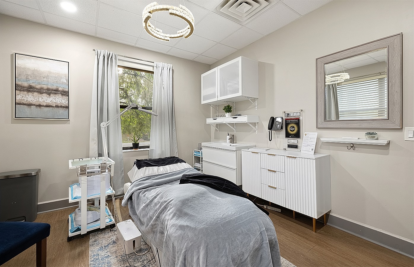 Spa treatment room with bed and decor.