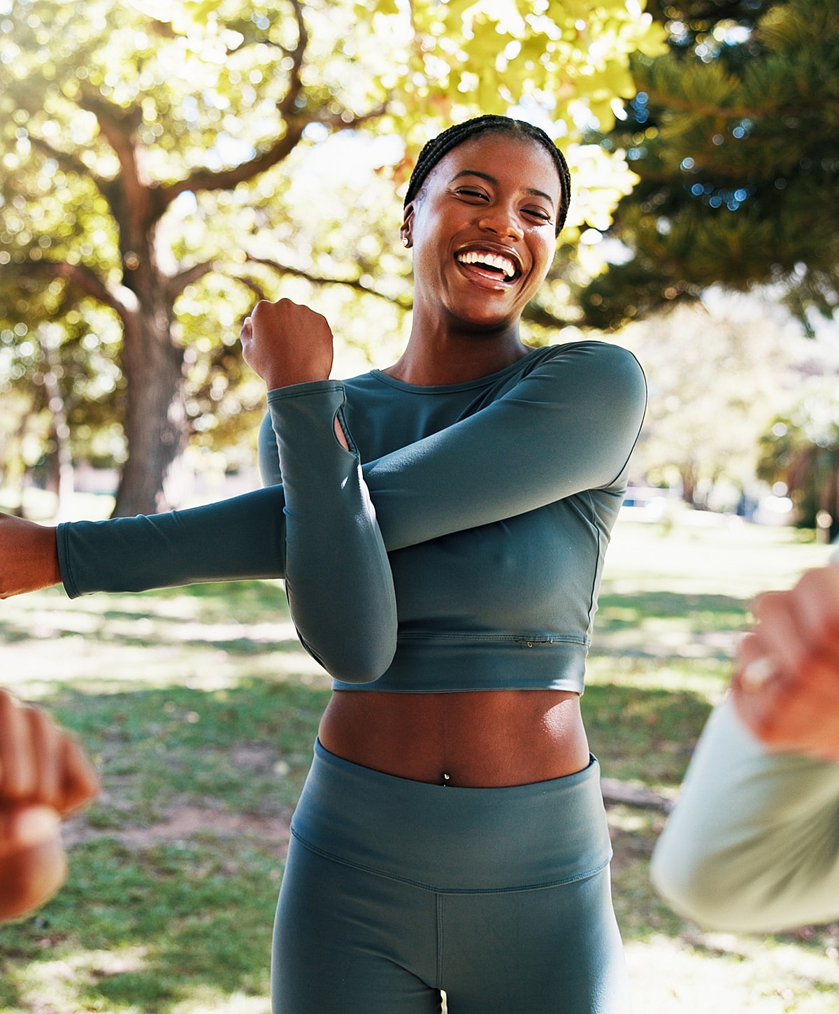 Happy woman exercising outdoors in casual fitness attire.