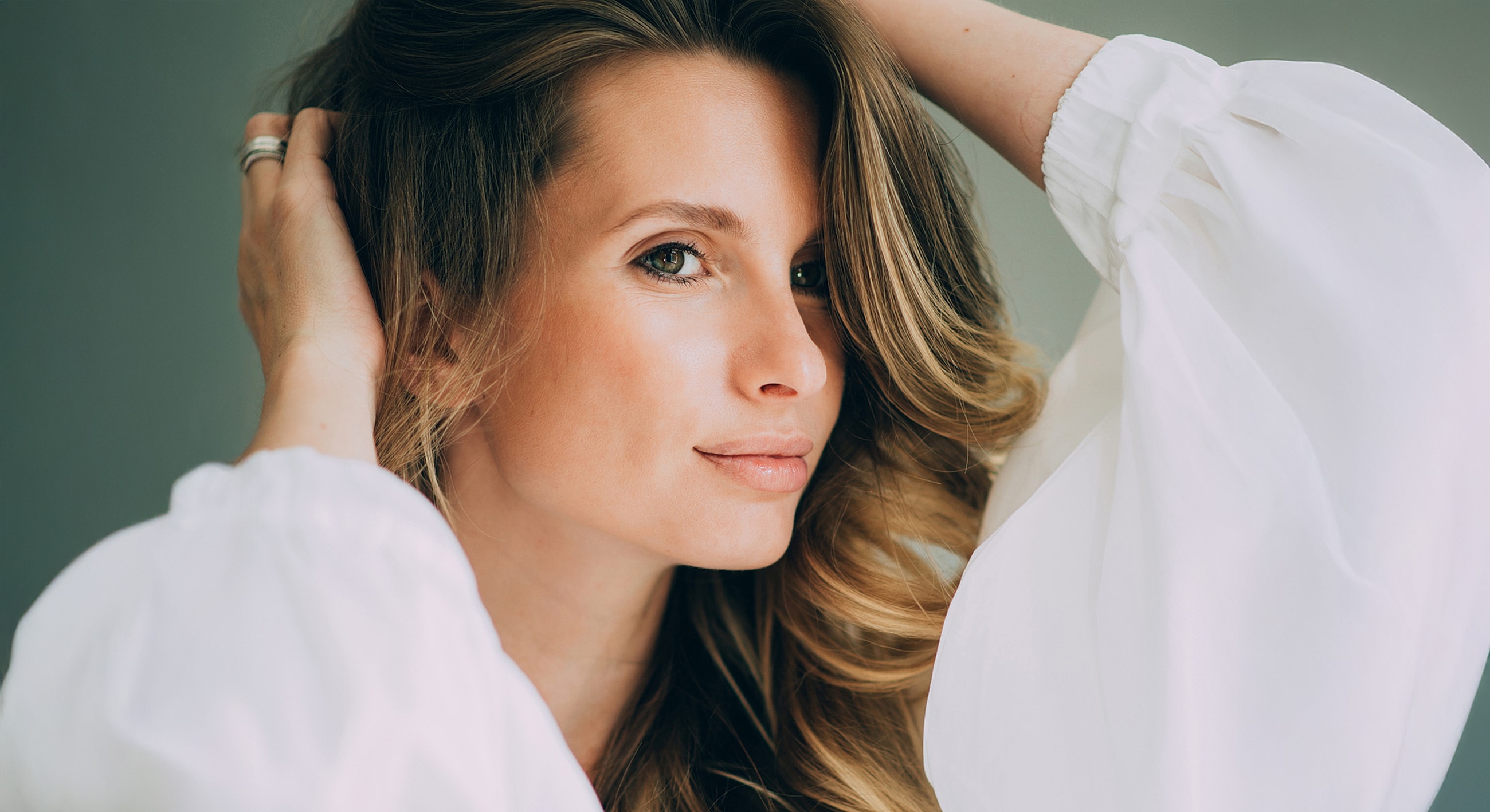 Woman with long hair in white blouse.