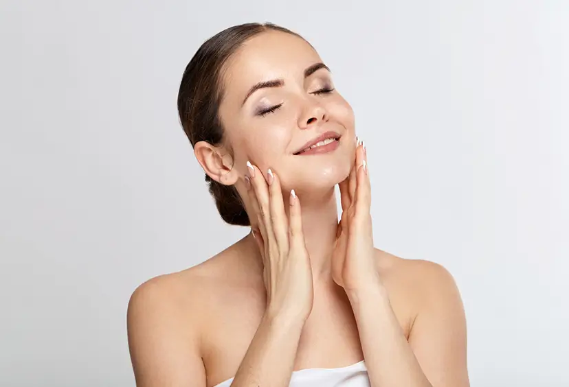 young woman holding her face